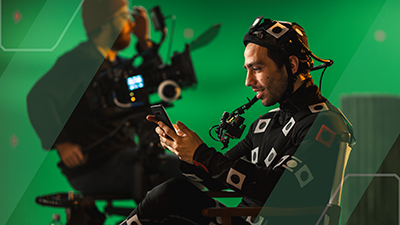 man in motion capture suit looking at his phone