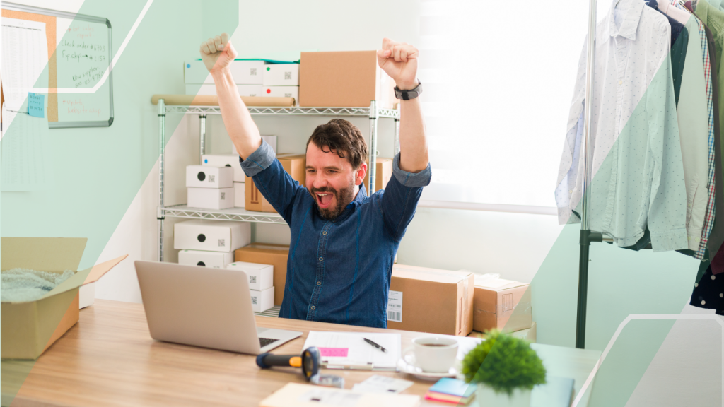 small business owner celebrating at his desk