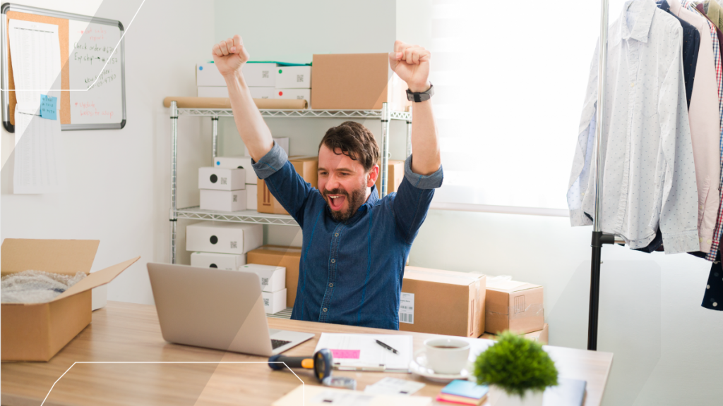 small business owner, celebrating at their desk
