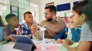 teacher discussing wind turbines with primary school children