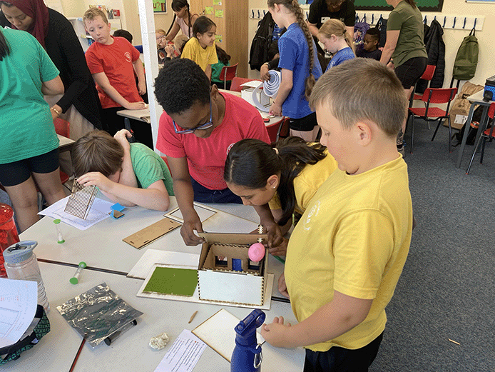 primary school pupils building houses