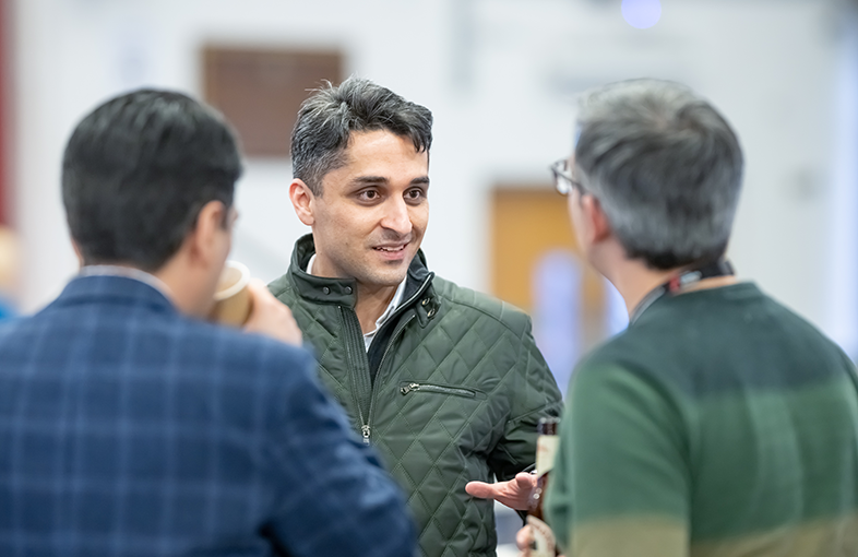 person speaking to two other people