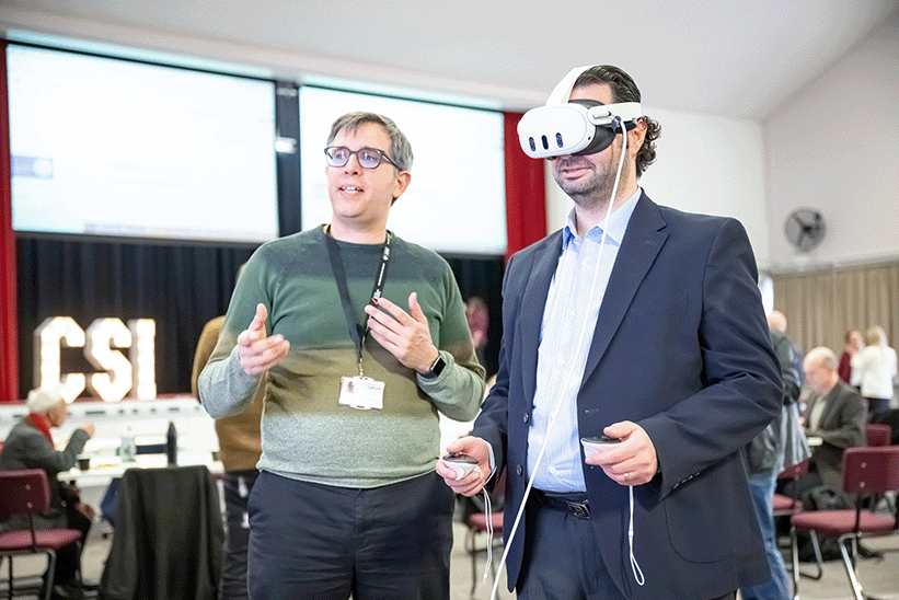 person explaining whilst someone is using VR headset